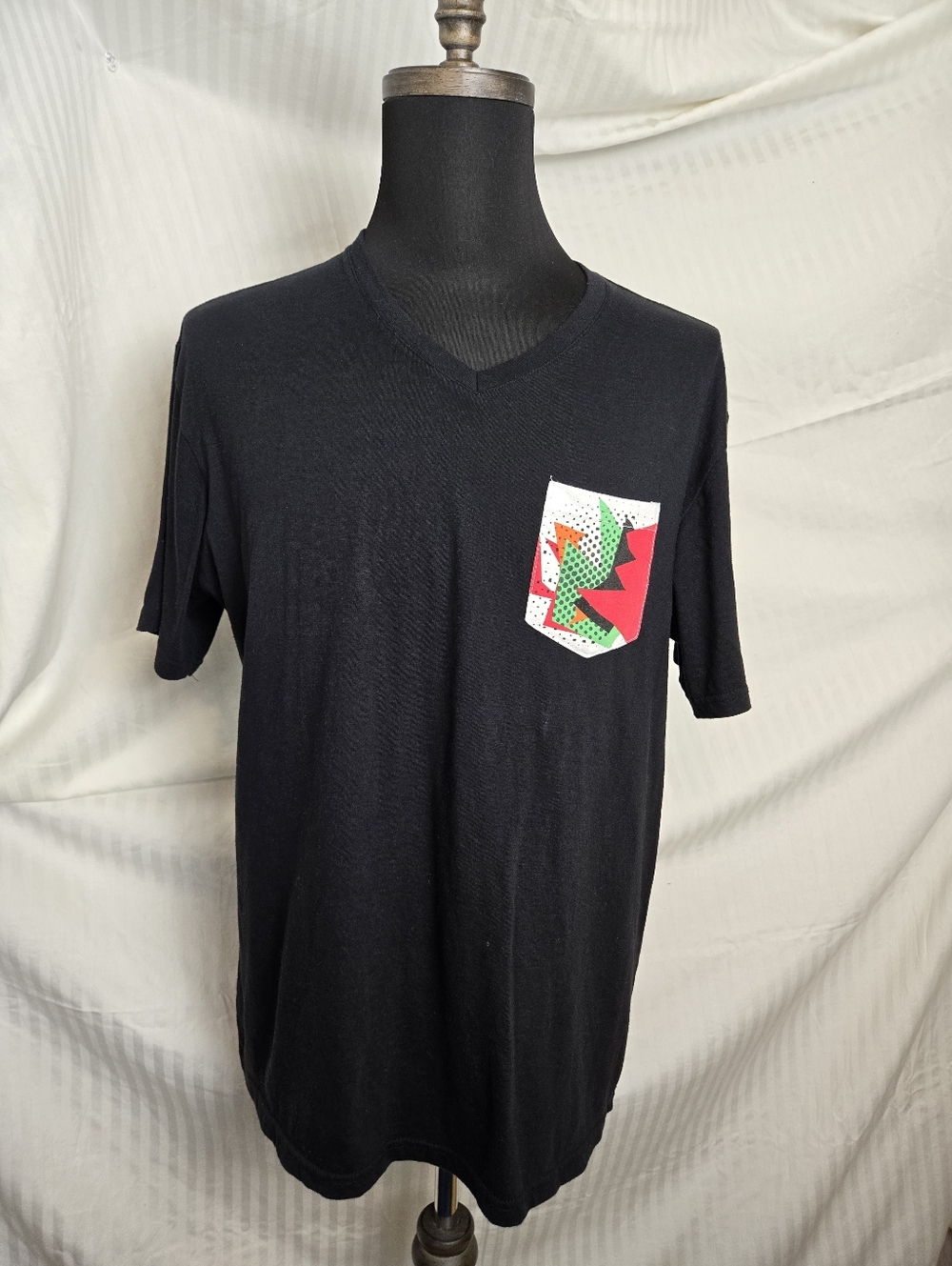 Black V-Neck Pocket Tee with Color Block Graphic. TM